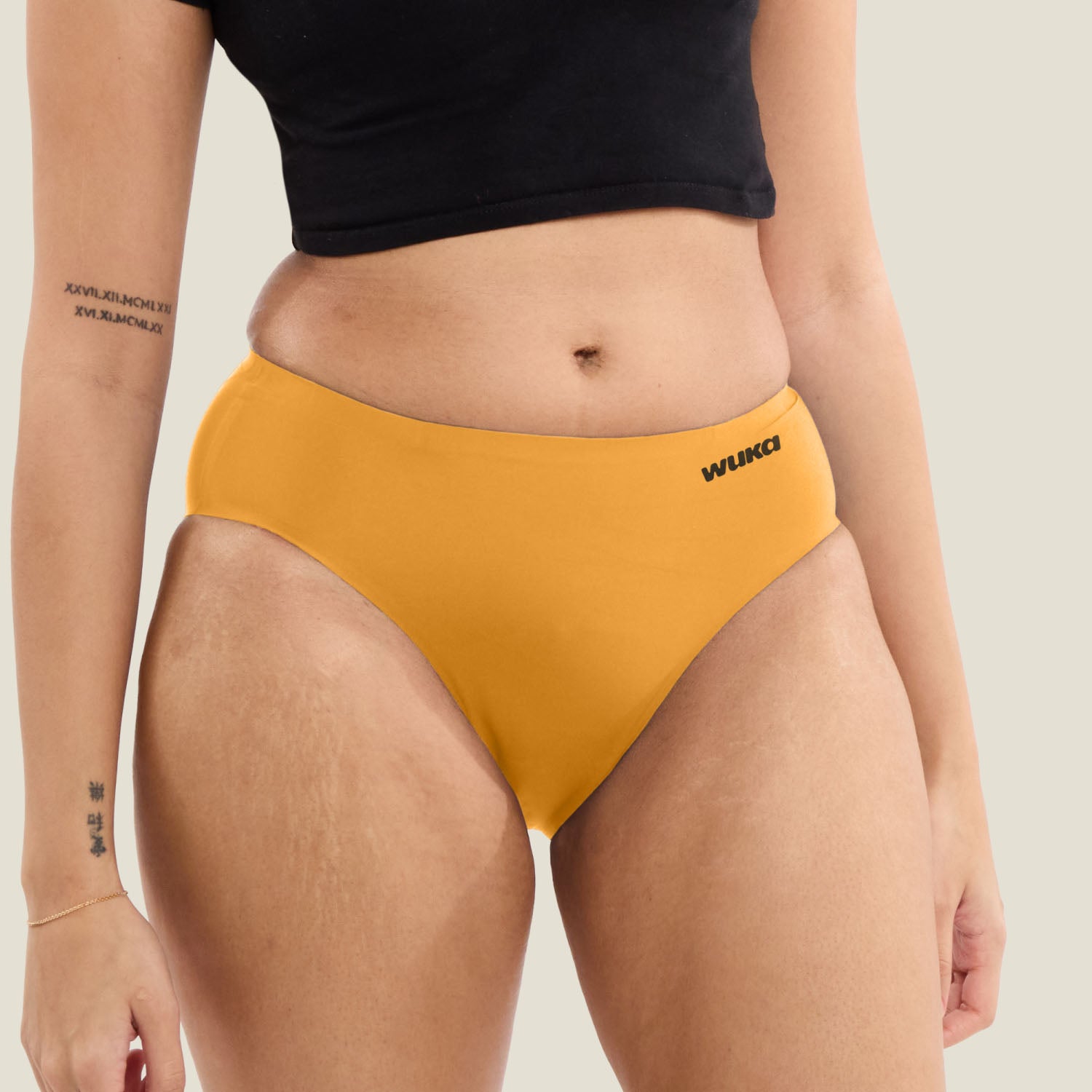 Front view of WUKA Teen Stretch Seamless Midi Brief in orange. Limited edition heavy flow period pants designed for comfort, absorbency and flexibility.