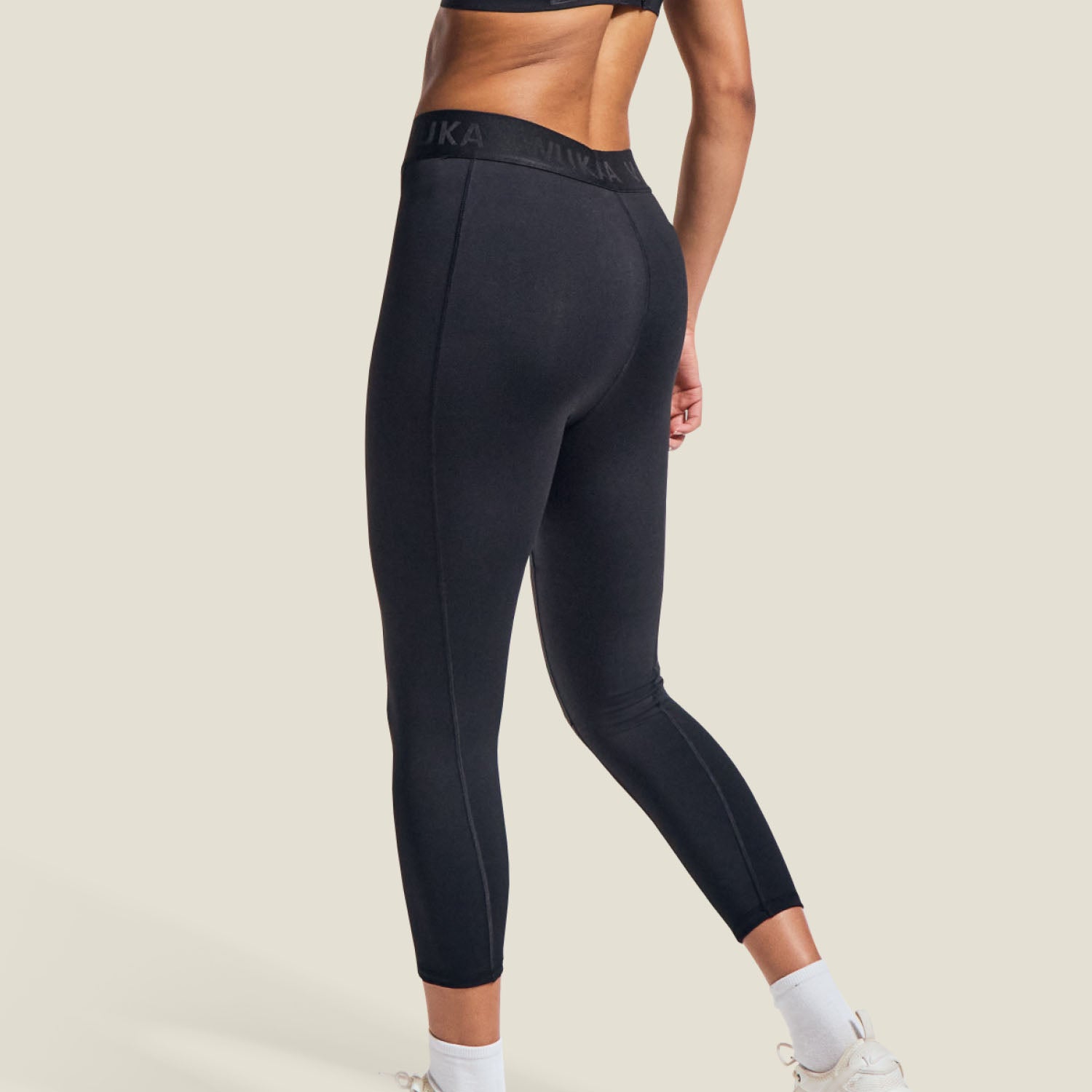 Back view of black WUKA Period Leggings, highlighting seam structure and shaping design for medium menstrual flow.