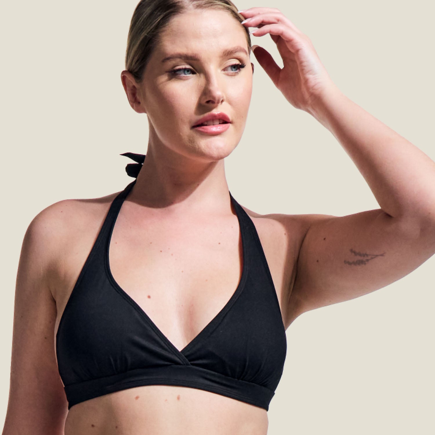 Detail shot of WUKA tie-back bikini top in black, focusing on the halter neckline and fabric quality.