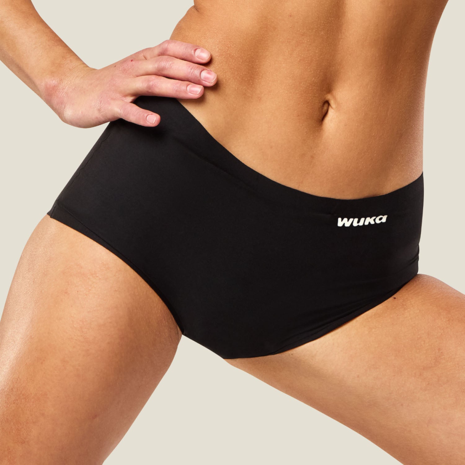 Close-up of active model in WUKA Stretch™ Boxer Short period pants in black, showcasing flexible fit for movement and comfort.