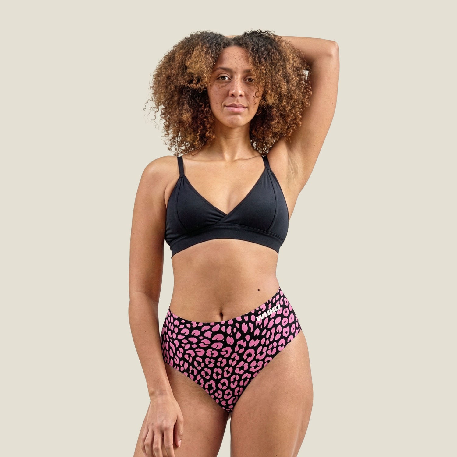 Model wearing WUKA Stretch™ midi brief in limited edition pink leopard print for heavy flow – full-body view showcasing fit and comfort