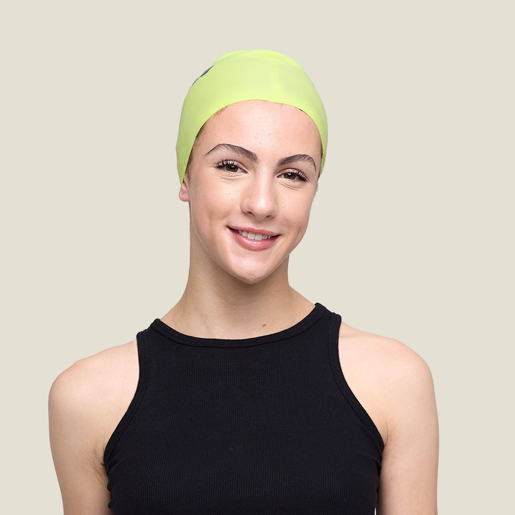 WUKA Lunafly lime punch silicone swim cap, worn by a teen swimmer — full length.