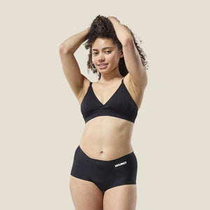 Teen model wearing WUKA Teen Stretch™ Period Boxer in black for heavy flow, full coverage comfort for first periods.