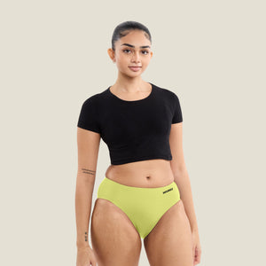 Teen wearing WUKA Stretch Seamless Midi Brief in limited edition Lime Punch, designed for heavy flow. Leak-proof period underwear with up to 12 hours of protection.