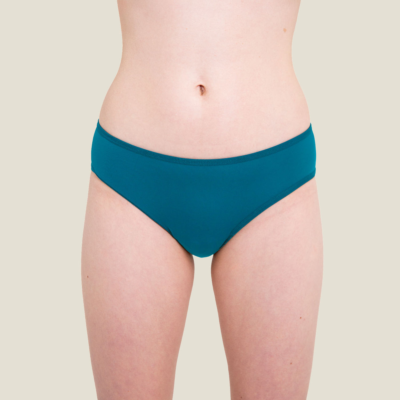 Front view of WUKA Teen Swim Bikini Brief in blue for light flow, showcasing fit, coverage, and comfortable waistband on a teen model.