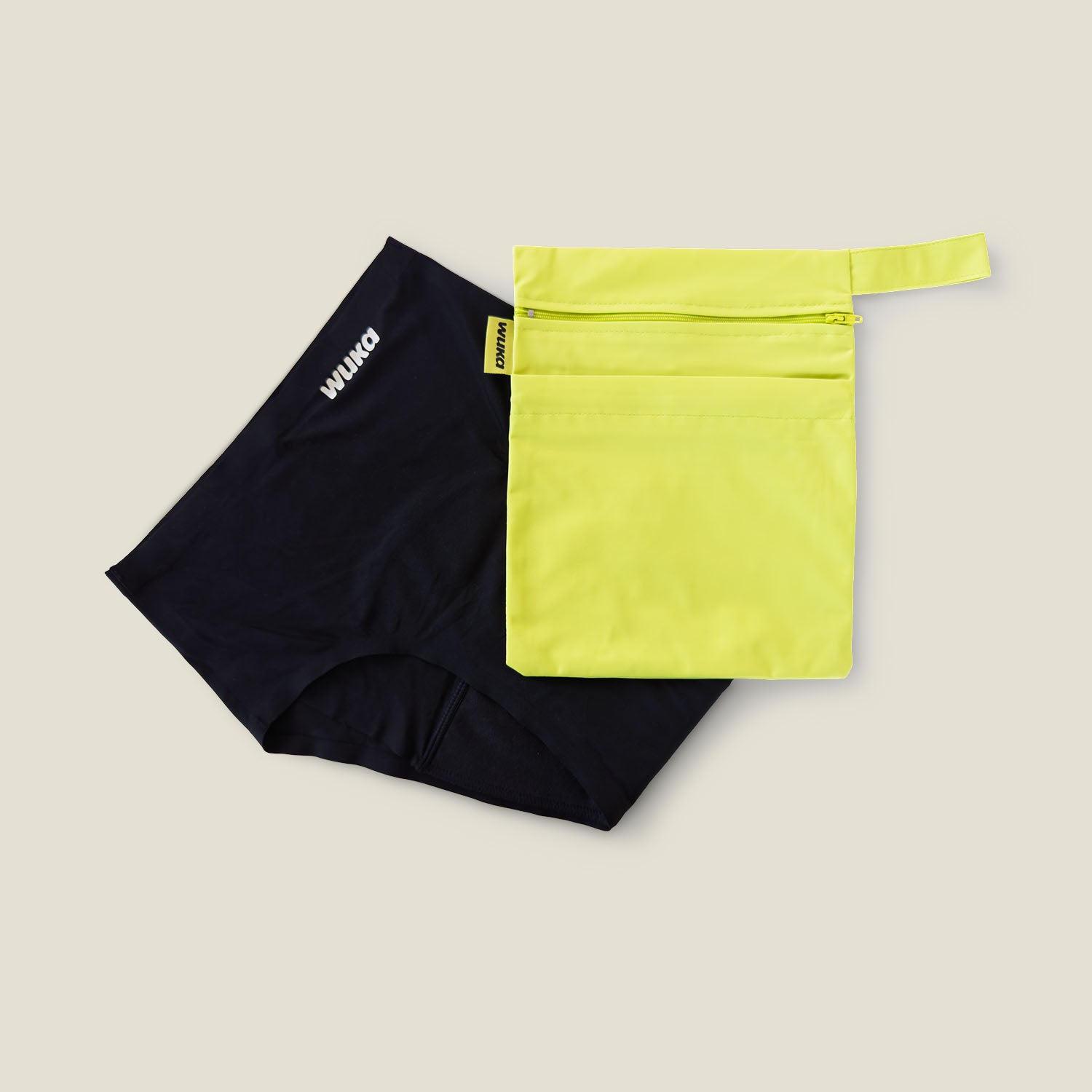 WUKA period pants and lime punch two-pocket changing bag shown together, designed for stress-free changes during periods or incontinence