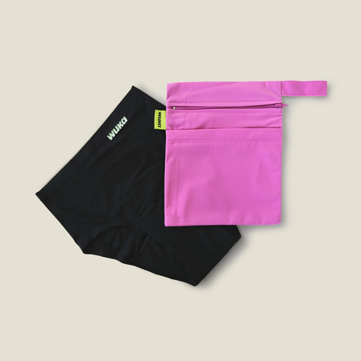 WUKA pink double-pocket changing bag shown with black reusable period pants for on-the-go menstrual care