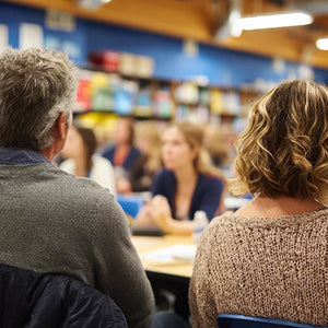 The back of parents' heads as they learn about their daughters' first period. WUKA Talks is for parents and carers who want guidance on how to talk about periods and puberty, and want appropriate information.